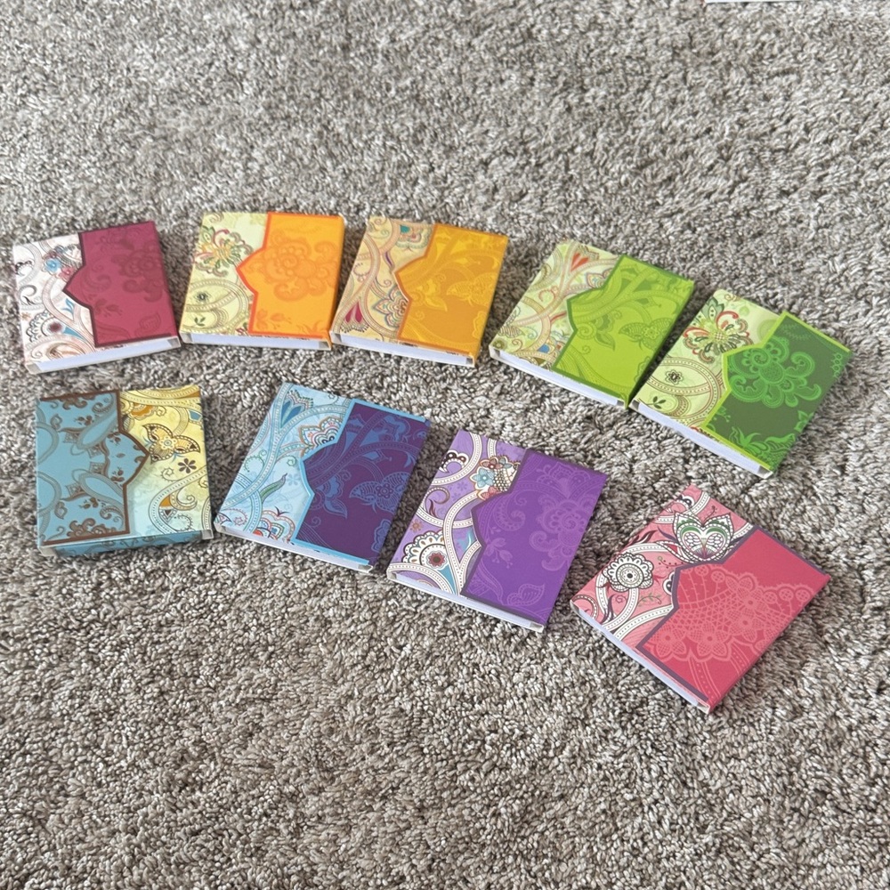 Set of Nine Colorful Paisley Patterned Notebooks